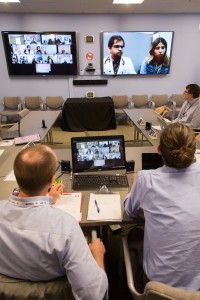 Bouchonville listens to a case presentation by Ninad Shet, MD (on screen) of La Casa Family Health Center in Roswell, N.M. On the left screen are primary care clinicians connecting to the teleclinic from across the state.